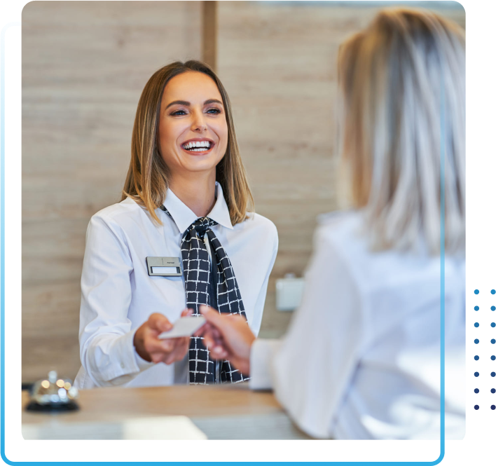 Receptionist and businesswoman at hotel front desk